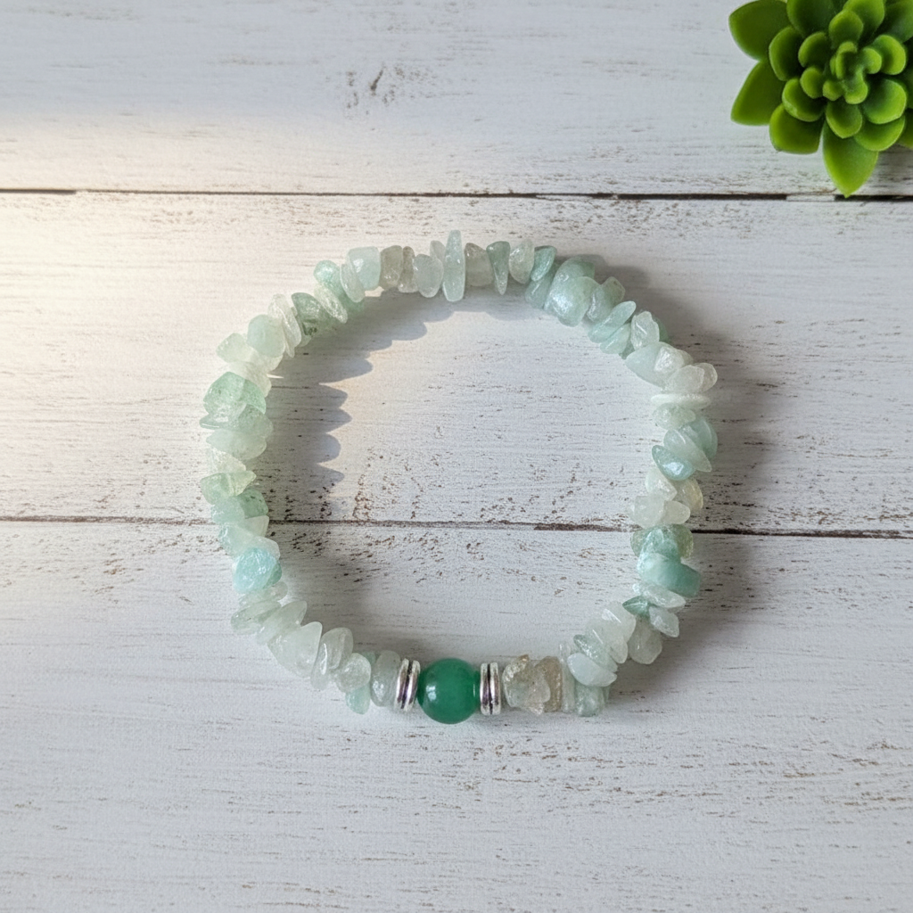 Natural Green Aventurine Crystal Chip Bracelet with Round Center Bead and Silver Spacers Displayed on White Wooden Surface | OneTrend
