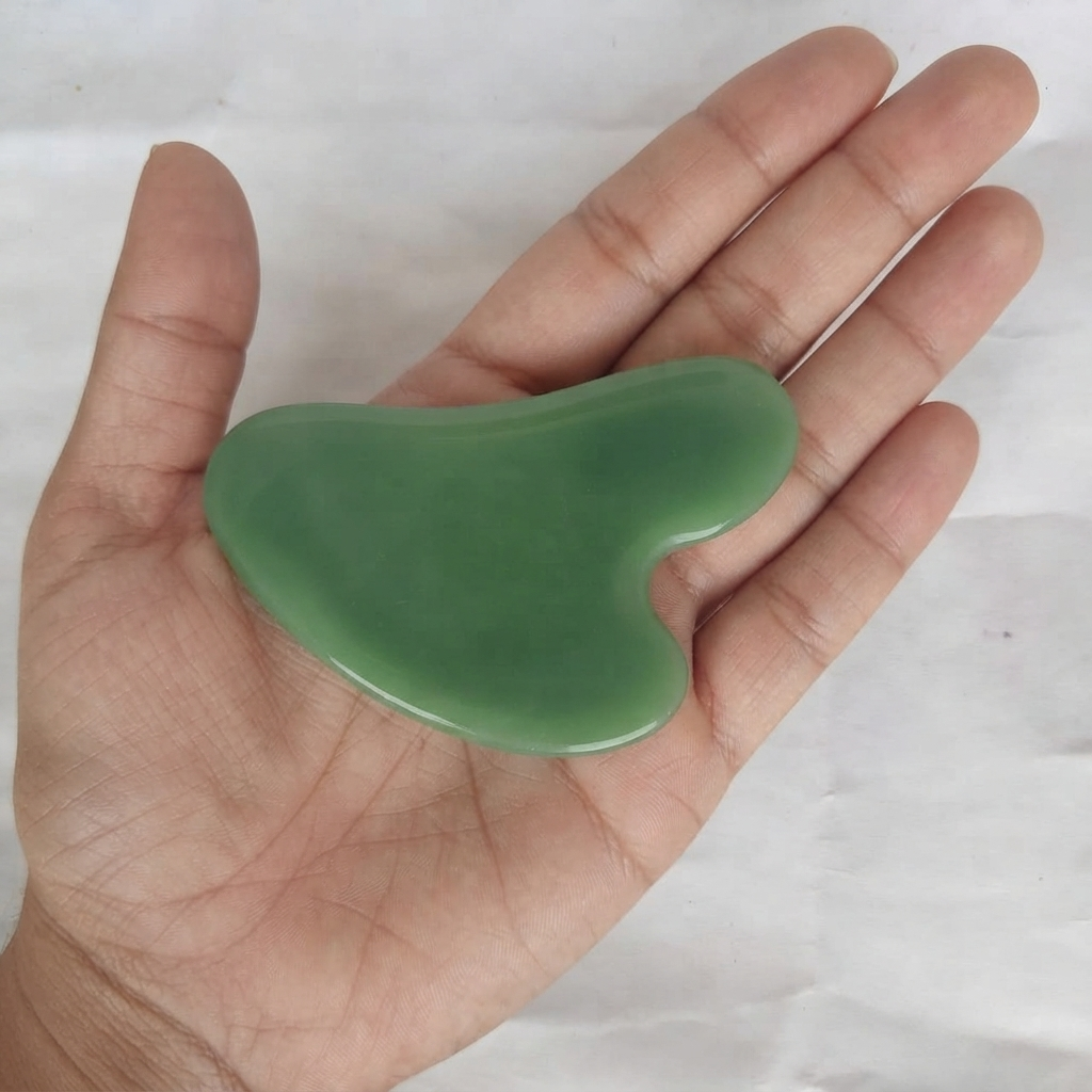 Jade Roller And Gua Sha Set Showing Double-Ended Green Face Roller With Gold-Tone Frame